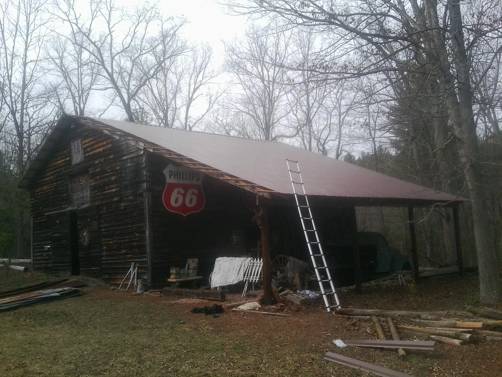 New metal roof on an open sided timber barn with a vintage sign in Pierce